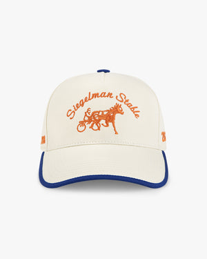 Front view of the 2026 New York Champions 5-panel hat, cream crown with royal blue trim and orange script and horse logo
