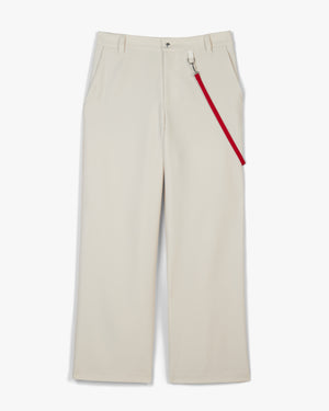 Front view of vaporous gray coaches pants with a red harness strap clipped at the belt loop