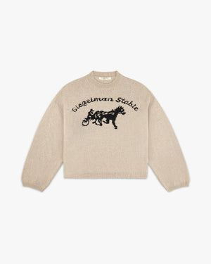 Front view of a chickpea tricot knit sweater with black Siegelman Stable script and horse and sulky logo