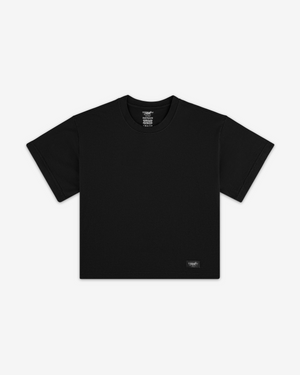 Front view of a black boxy tee with a small Siegelman Stable woven label at the lower hem