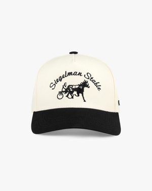 Front view of a cream and black two-tone 5-panel cap with black Siegelman Stable script and horse and sulky embroidery