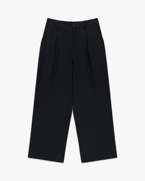 Front view of black pleated wide leg trousers with front pleats