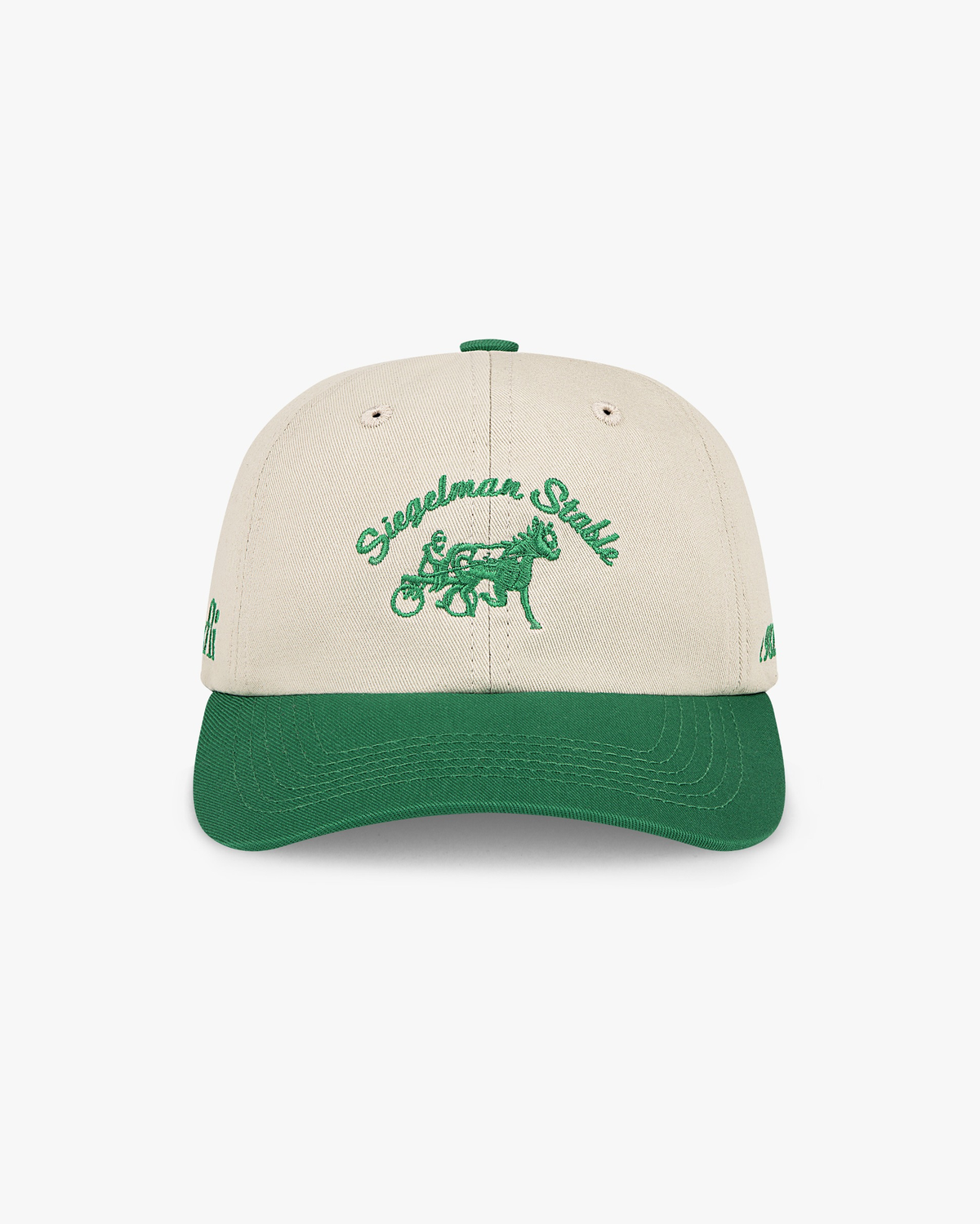 Front view of the Maxfli x Siegelman Stable dad hat, off-white crown, kelly green visor and green script and horse logo