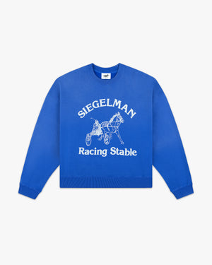 Front view of a cobalt crewneck with white arched Siegelman, horse and sulky graphic and Racing Stable script
