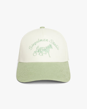 Front view of a cream and seafoam two-tone 5-panel cap with seafoam Siegelman Stable script and horse and sulky embroidery