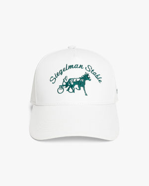 Front view of a white 5-panel cap with green Siegelman Stable script and horse and sulky embroidery