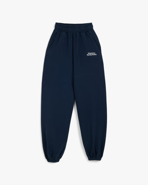 Front view of navy New York Racing Stable sweatpants with small white text at the left hip and elastic cuffs