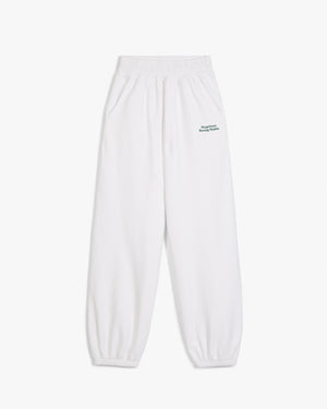 Front view of white Racing Stable sweatpants with small green Siegelman Racing Stable text at the left hip