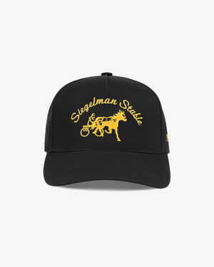 Front view of a black 5-panel cap with university gold Siegelman Stable script and horse and sulky embroidery