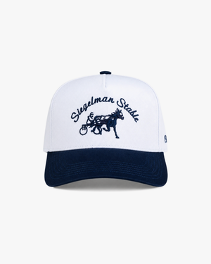 Front view of a white and navy two-tone 5-panel cap with navy Siegelman Stable script and horse and sulky embroidery