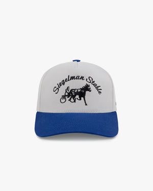 Front view of a gray and blue two-tone 5-panel cap with black Siegelman Stable script and horse and sulky embroidery
