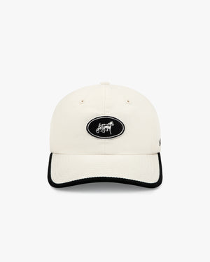 Front view of a cream dad hat with black oval horse and sulky patch and black visor trim