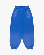 Front view of faded cobalt sweatpants with small white Siegelman Racing Stable text at the left hip