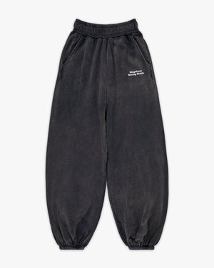 Front view of black enzyme-wash sweatpants with small white Siegelman Racing Stable text at the left hip