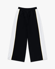 Front view of black wide leg track pants with white side panels and a thin yellow stripe