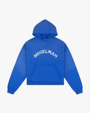 Front view of a cobalt blue Racing Stable hoodie with arched white Siegelman lettering and kangaroo pocket